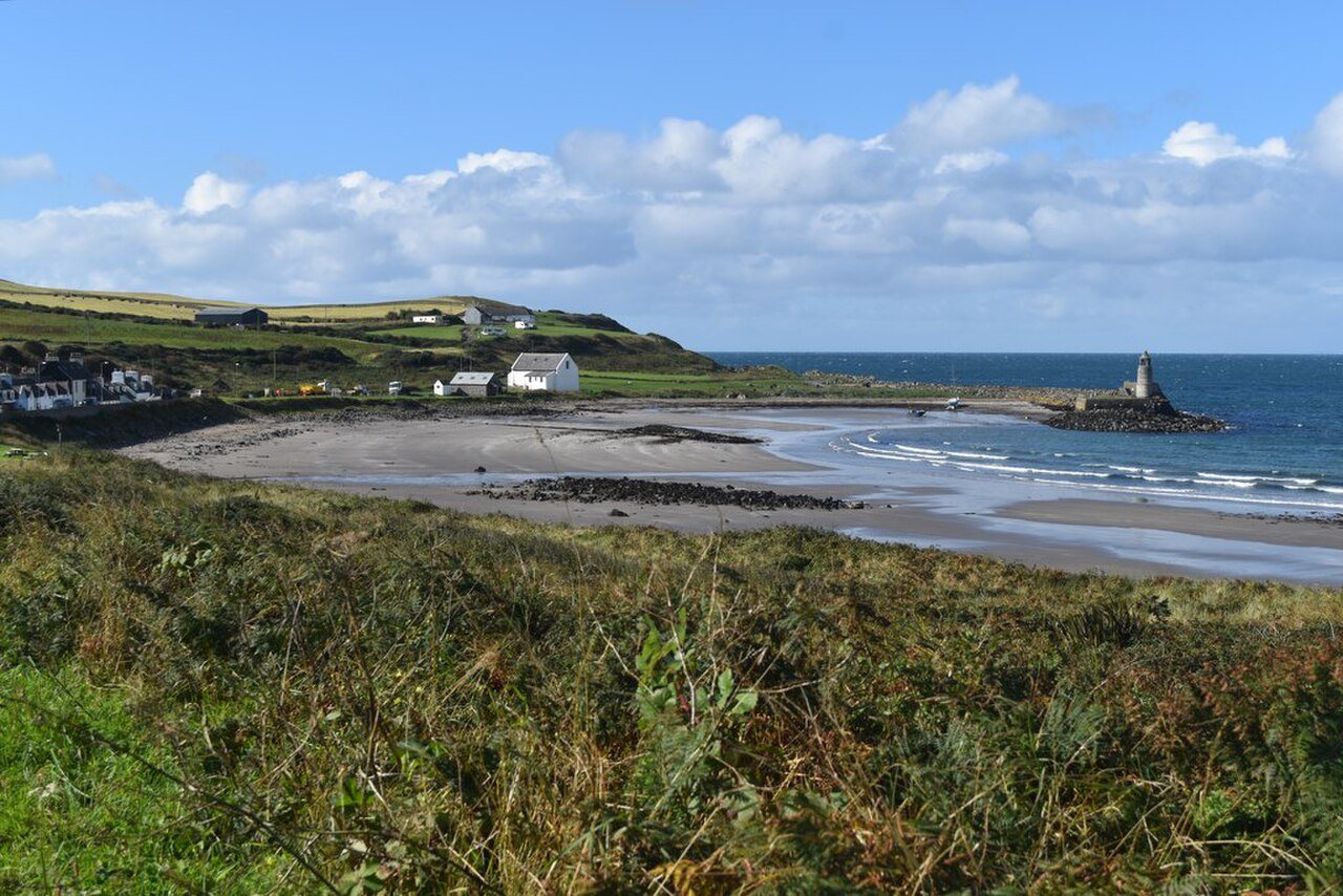 Port Logan village and harbour beside the bay.