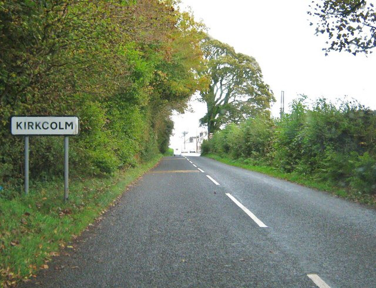 A village name sign beside the road into Kirkcolm.