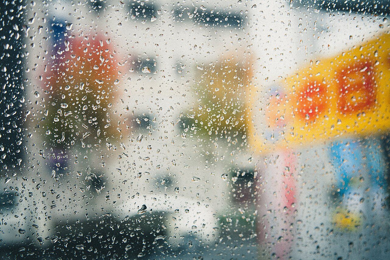 Raindrops on a window, shown as a rainy-day illustration.